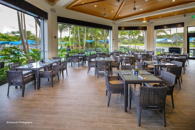 exterior space featuring wooden ceiling, vaulted ceiling, and plenty of natural light