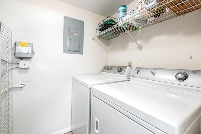 laundry area with electric panel and washer and clothes dryer