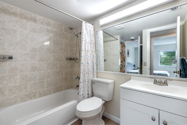 full bathroom featuring vanity, toilet, and shower / bathtub combination with curtain