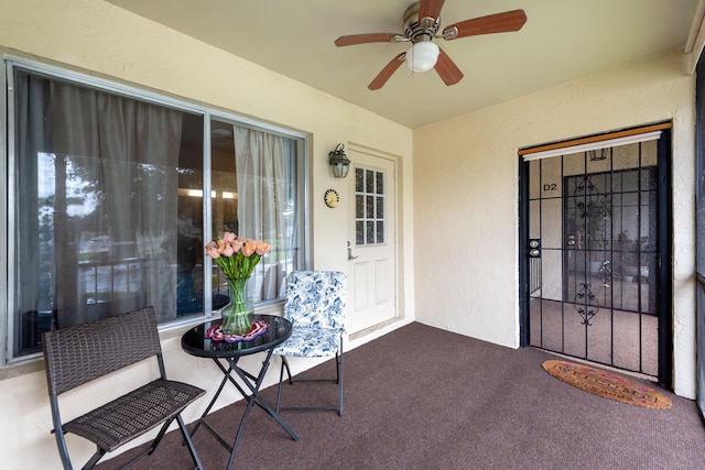 view of exterior entry featuring ceiling fan