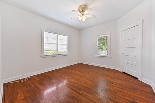 empty room featuring ceiling fan and dark wood-type flooring