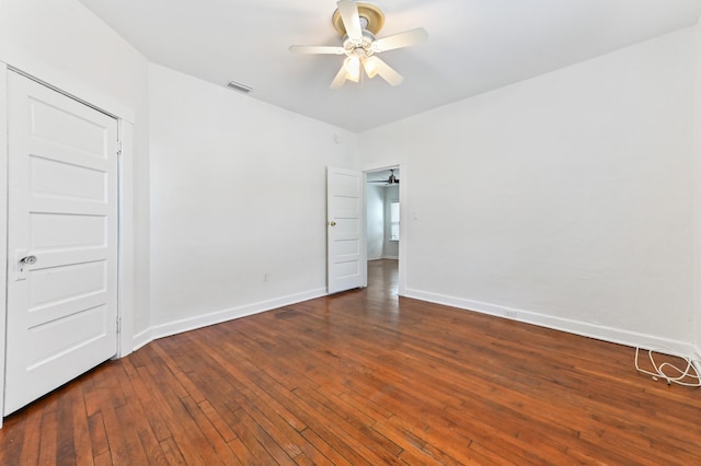 unfurnished bedroom featuring ceiling fan and dark wood-type flooring