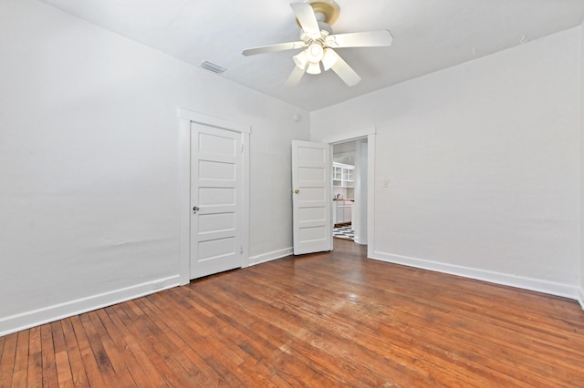 unfurnished bedroom with dark wood-type flooring and ceiling fan