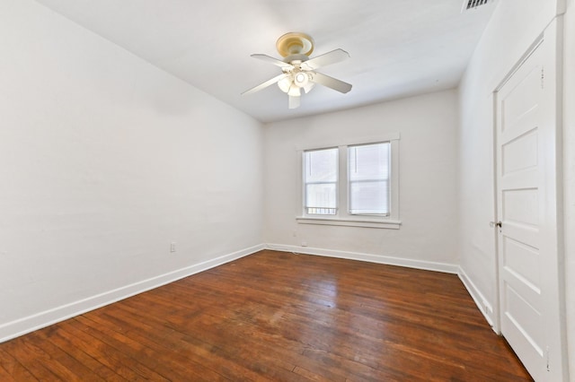 unfurnished room with ceiling fan and dark wood-type flooring