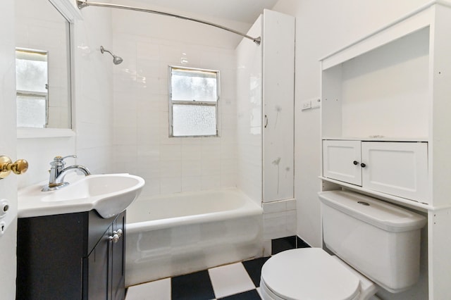 full bathroom with toilet, vanity, and tiled shower / bath