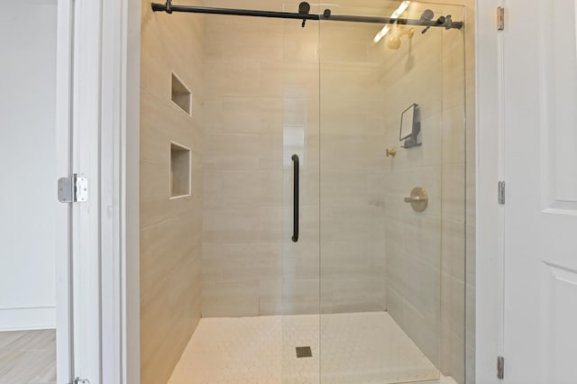 bathroom featuring a shower with shower door