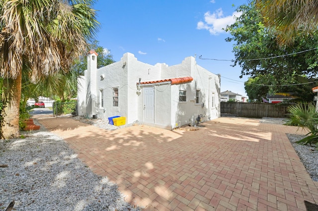 back of property with a patio