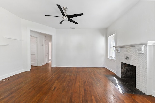 unfurnished living room with ceiling fan, dark hardwood / wood-style floors, and a fireplace