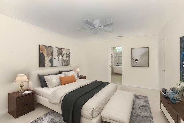 carpeted bedroom with ensuite bathroom and ceiling fan