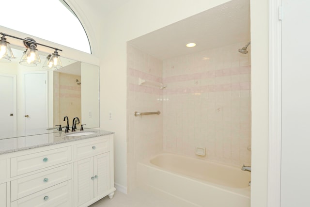 bathroom with vanity and tiled shower / bath