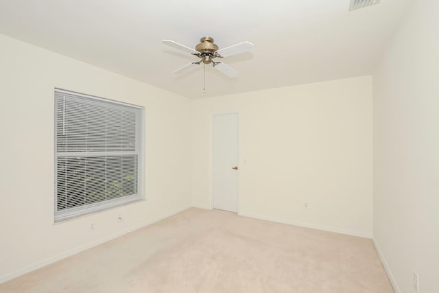 carpeted empty room featuring ceiling fan