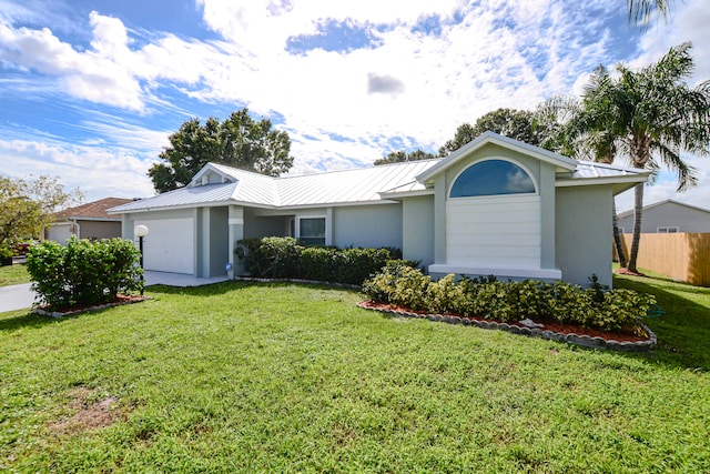 single story home featuring a garage and a front lawn