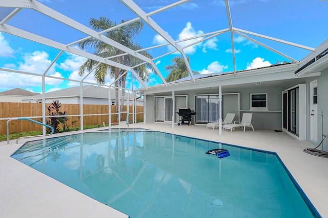 view of pool featuring a patio and glass enclosure