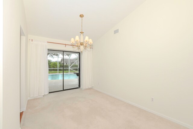 unfurnished room with high vaulted ceiling, light carpet, and a notable chandelier