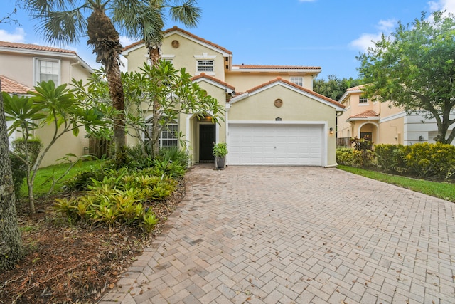 mediterranean / spanish house featuring a garage