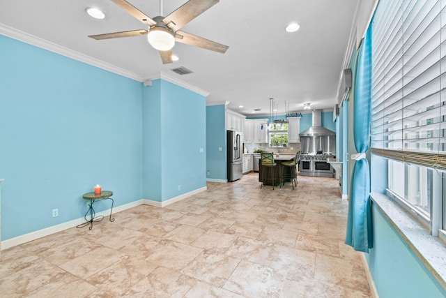 living room with ceiling fan and crown molding