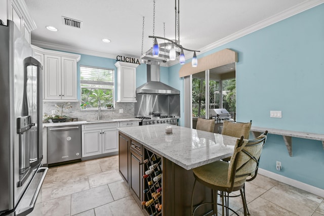 kitchen featuring decorative backsplash, stainless steel appliances, white cabinets, sink, and ornamental molding