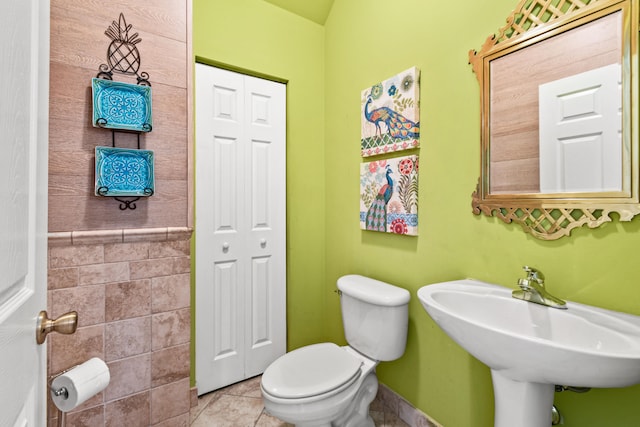 bathroom featuring sink, tile patterned flooring, and toilet