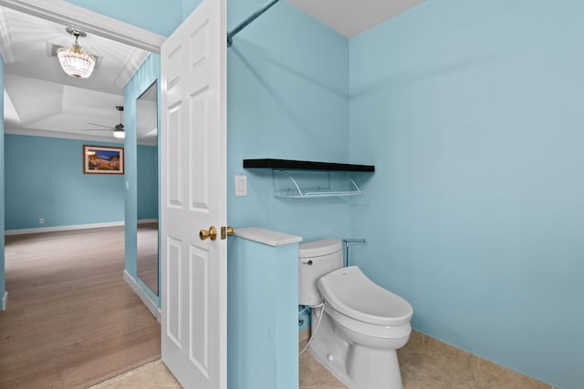 bathroom featuring ceiling fan, hardwood / wood-style floors, and toilet