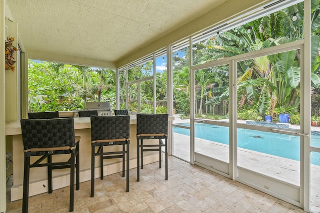 sunroom / solarium featuring a healthy amount of sunlight