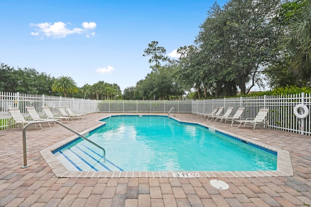 pool featuring a patio and fence