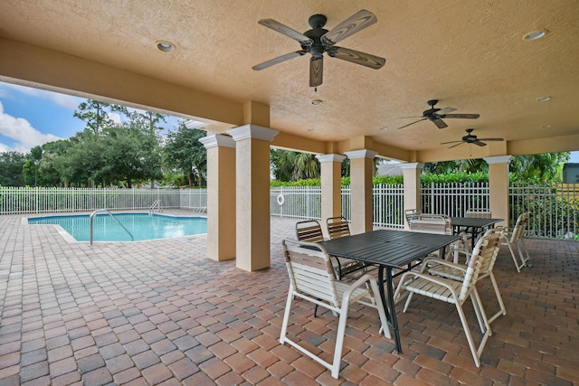 view of swimming pool featuring ceiling fan and a patio