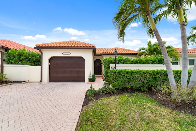 mediterranean / spanish home with a garage