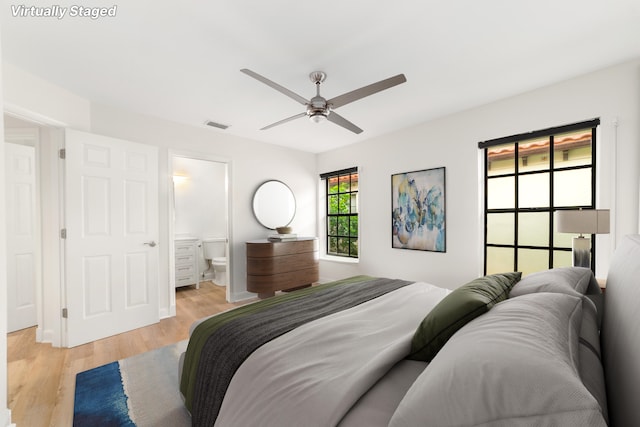 bedroom featuring ceiling fan, connected bathroom, and light hardwood / wood-style flooring