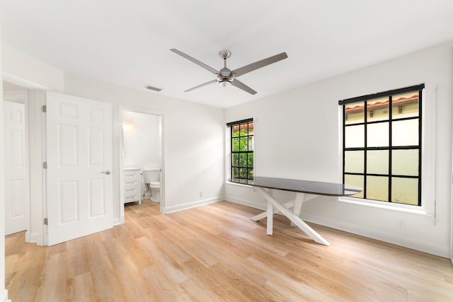 interior space featuring light hardwood / wood-style floors, connected bathroom, and ceiling fan