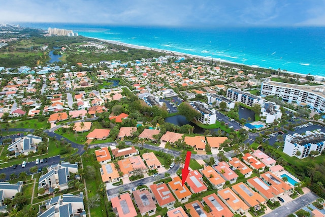 drone / aerial view with a water view and a view of the beach