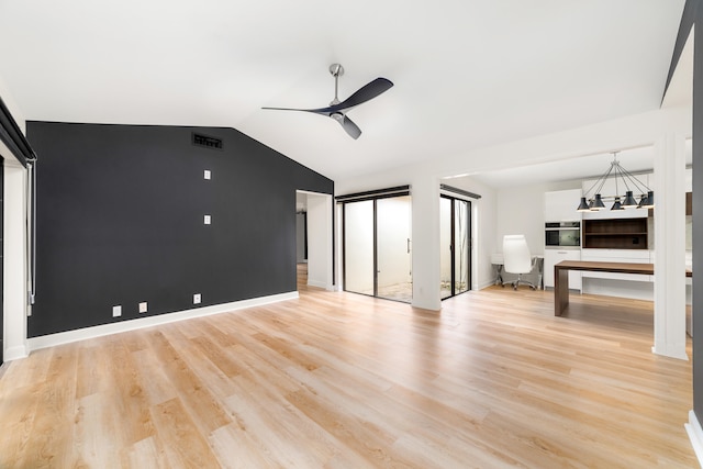 unfurnished living room featuring ceiling fan with notable chandelier, lofted ceiling, and light hardwood / wood-style flooring