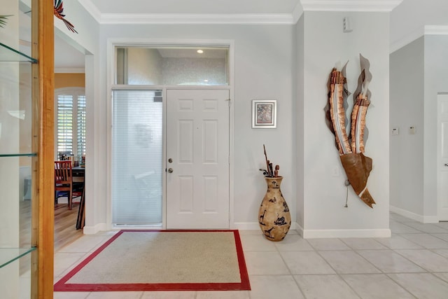 tiled foyer entrance featuring ornamental molding