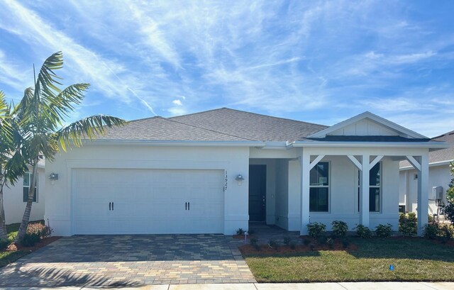 view of front of home with a lawn and a garage