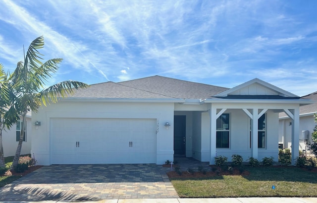 view of front of house featuring a garage and a front lawn