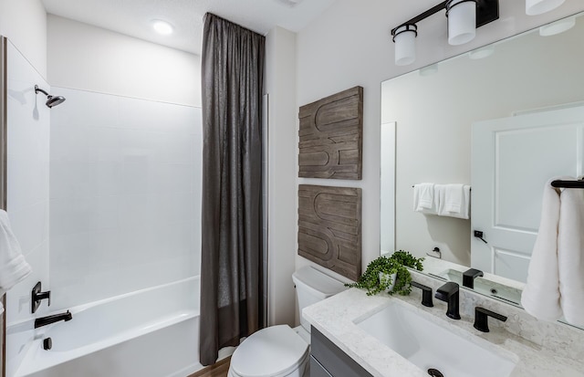 bathroom featuring shower / bath combo, vanity, and toilet