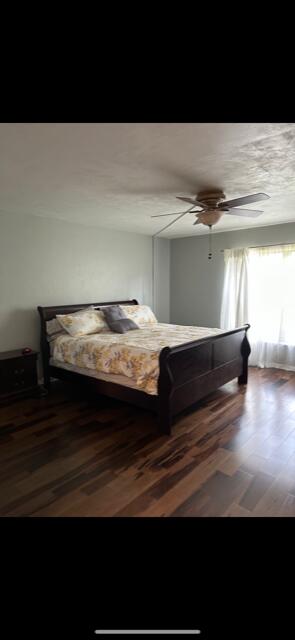 bedroom with hardwood / wood-style flooring and ceiling fan