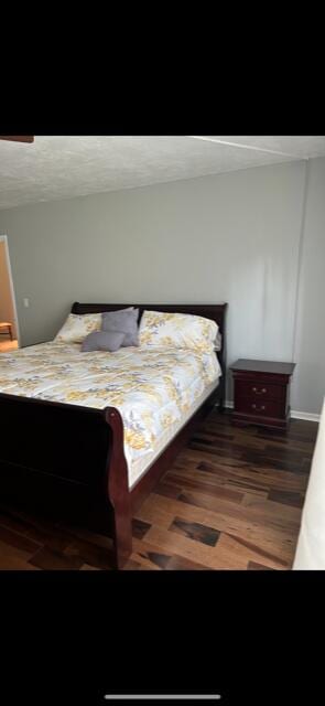 bedroom featuring ceiling fan and dark hardwood / wood-style flooring