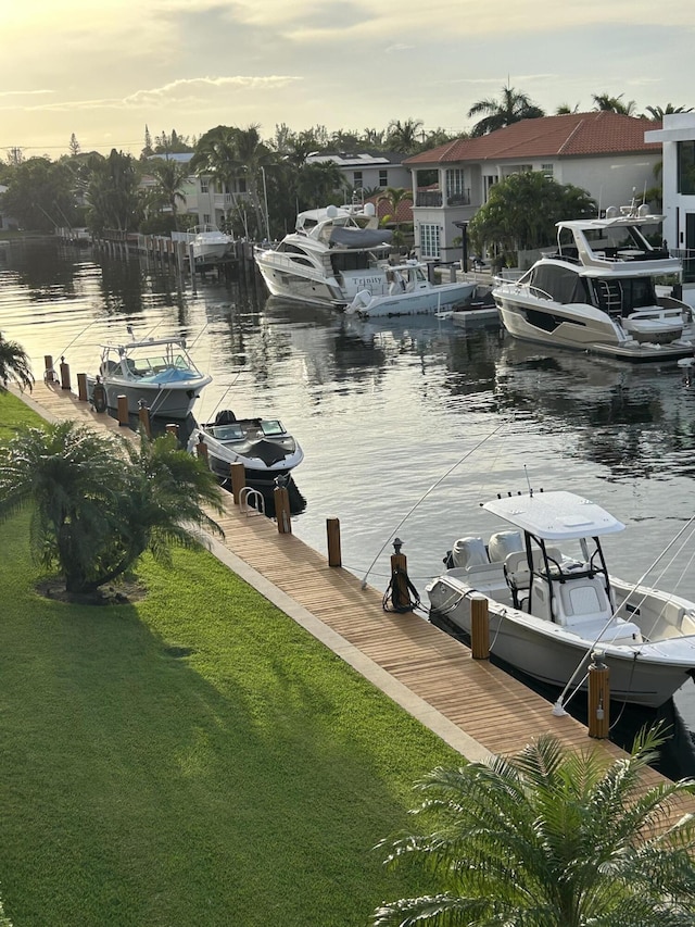 dock area featuring a water view and a yard