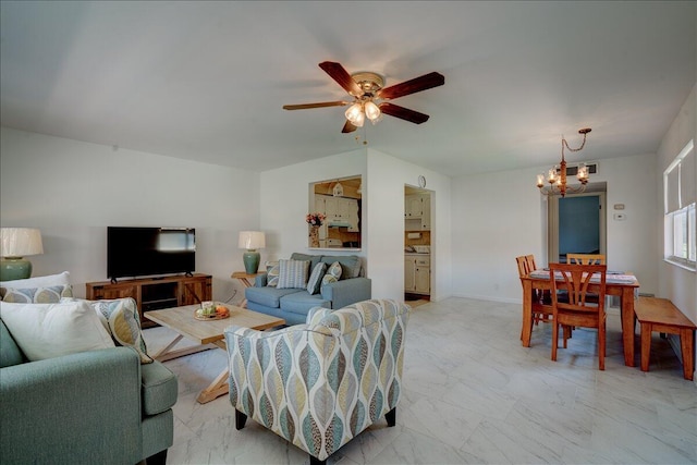 living room featuring ceiling fan with notable chandelier