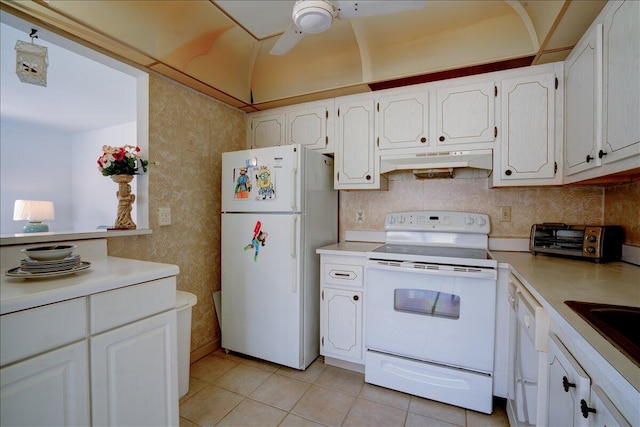 kitchen with white appliances, light tile patterned floors, and white cabinetry