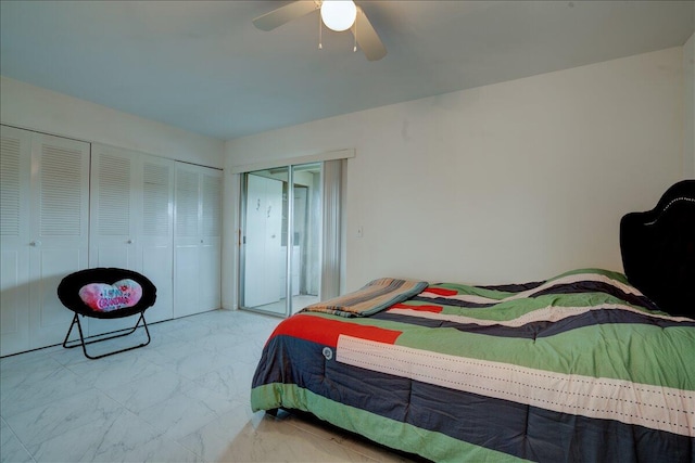 bedroom with ceiling fan and multiple closets