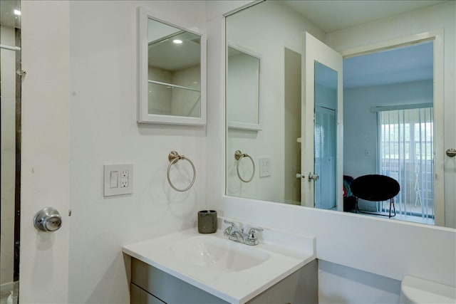 bathroom featuring vanity and toilet