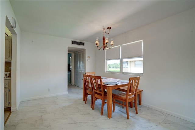 dining area featuring an inviting chandelier