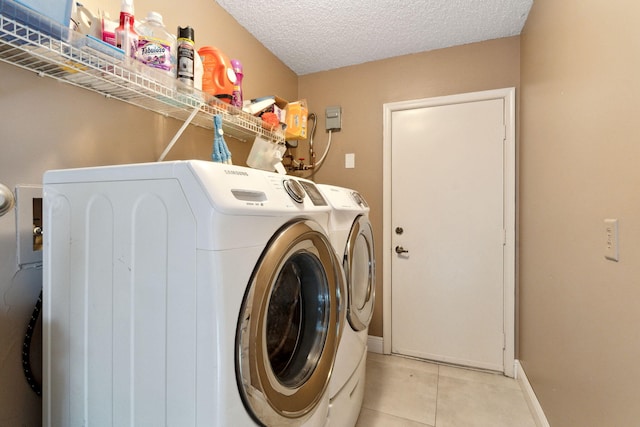 laundry room with washer and clothes dryer and a textured ceiling