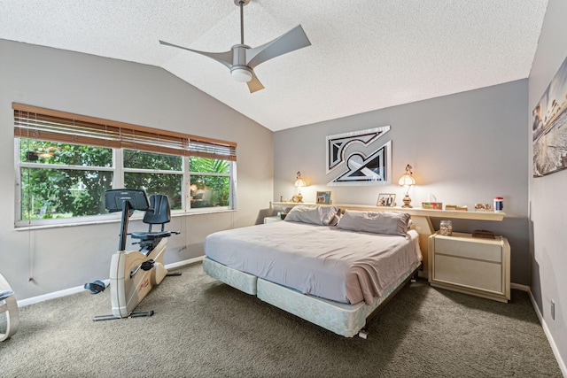 bedroom with vaulted ceiling, dark carpet, a textured ceiling, and ceiling fan