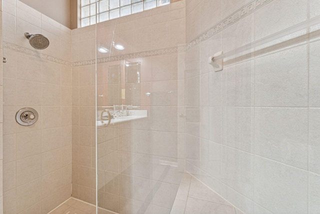 bathroom with tiled shower