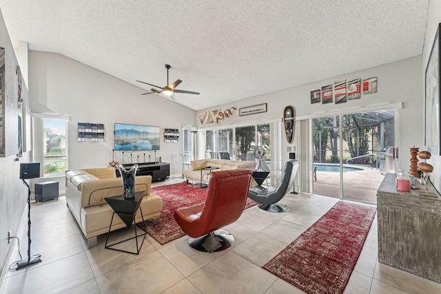 tiled living room with ceiling fan, a textured ceiling, and plenty of natural light