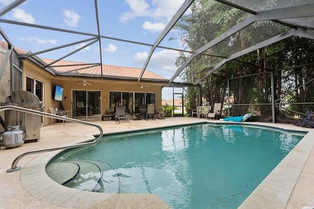 view of pool featuring ceiling fan, a lanai, and a patio area