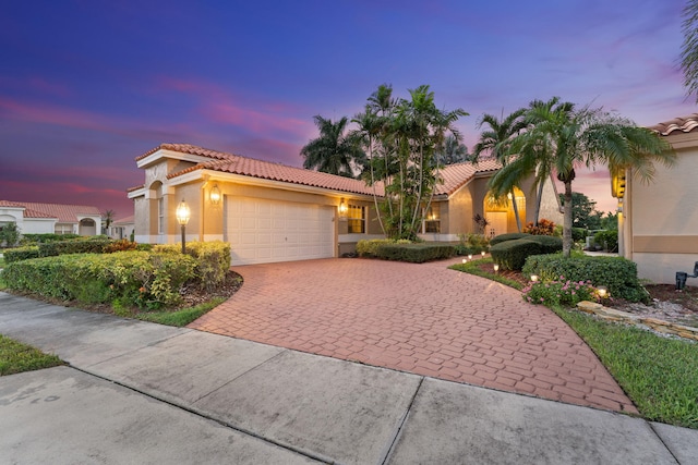 mediterranean / spanish-style home with a garage