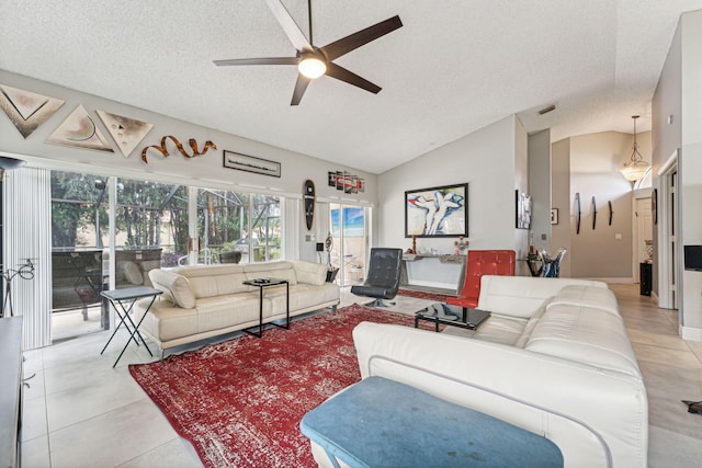 living room with ceiling fan, a textured ceiling, lofted ceiling, and light tile patterned flooring